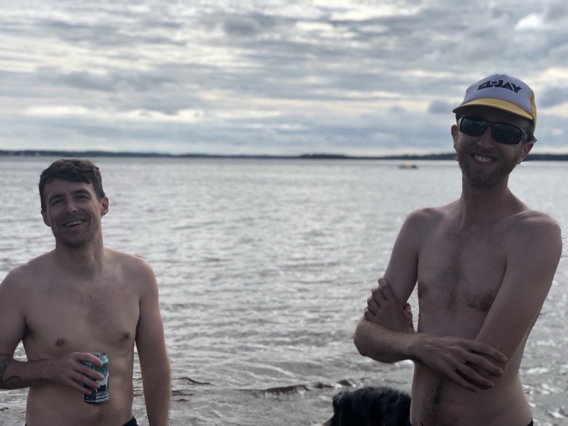 Two friends smiling at the beach